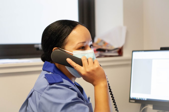Photograph of a nurse talking on a phone